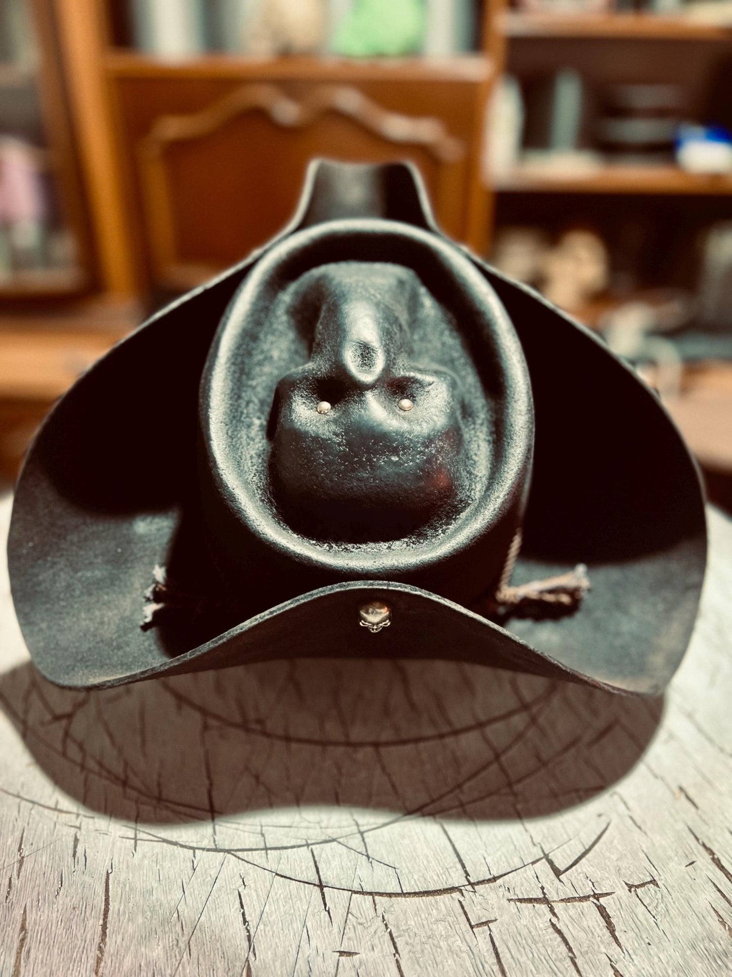 Black artisan pirate hat for adults made of leather with skull detail on front by JonHats