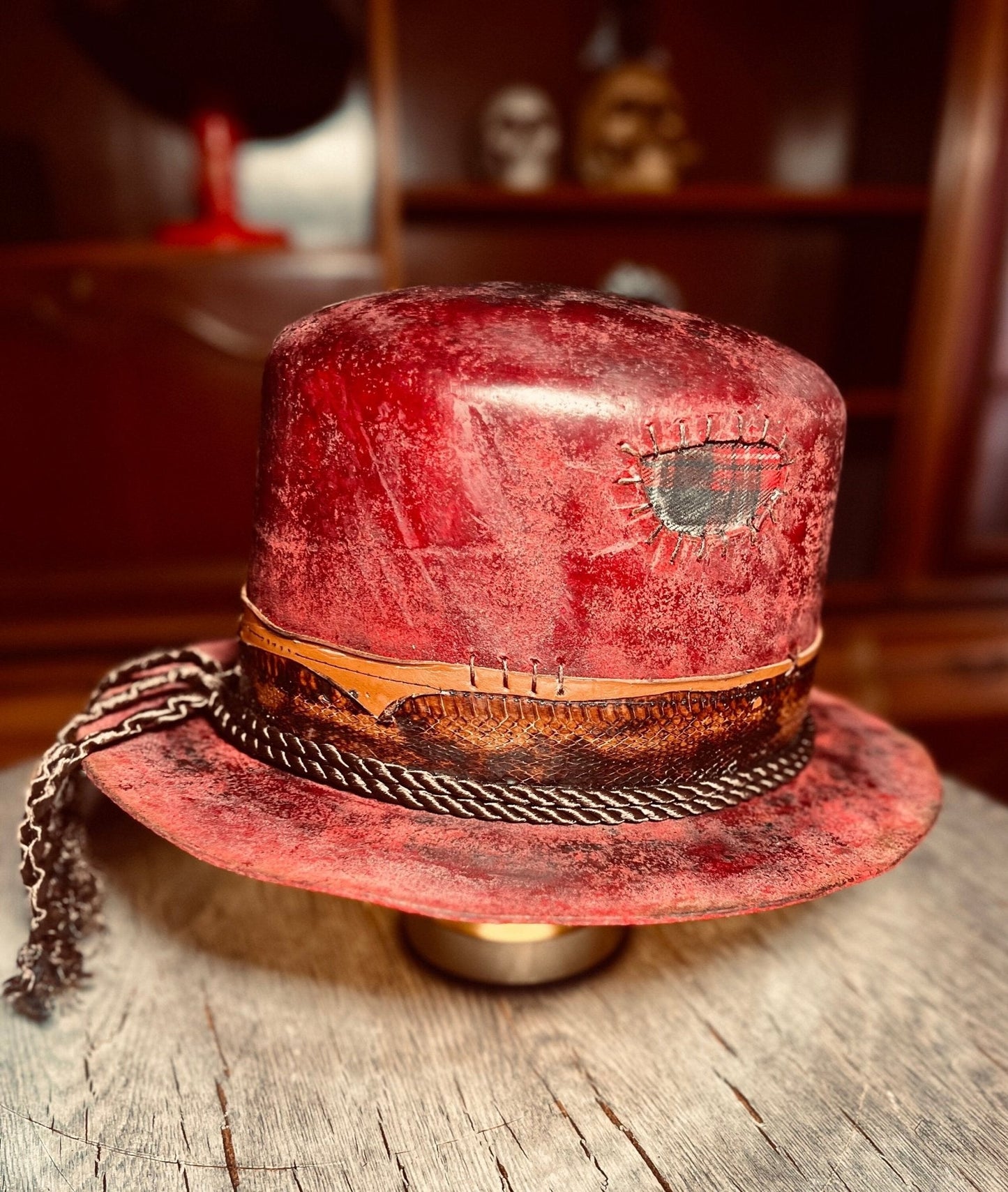 Artisanal open crown hat in distressed red leather with stitched patch and braided band by JonHats