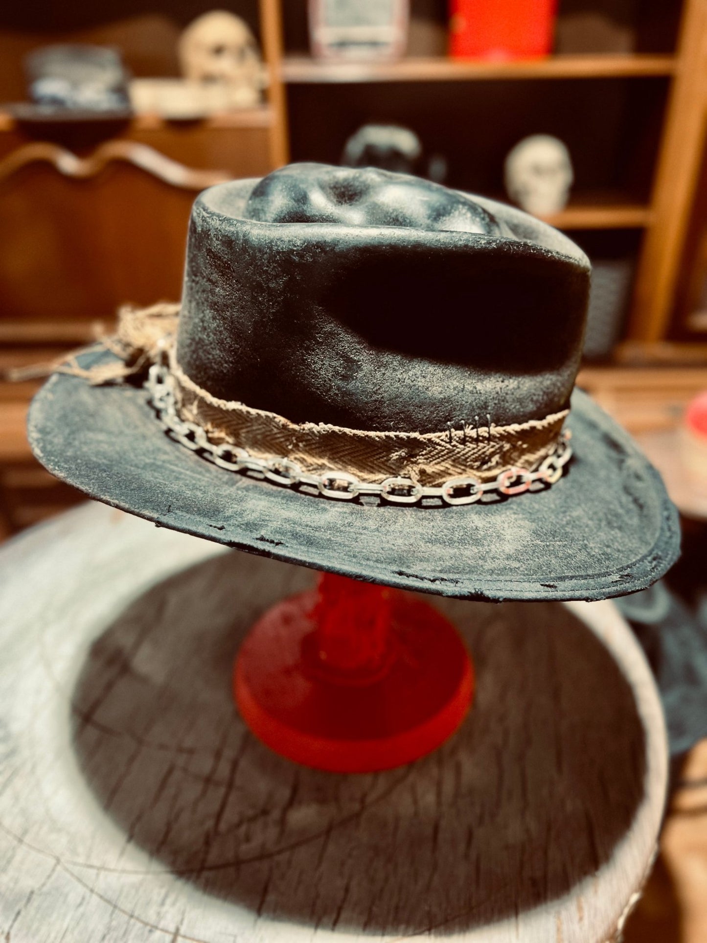 JonHats vintage men's artisan hat in black with chain and fabric band detail on display