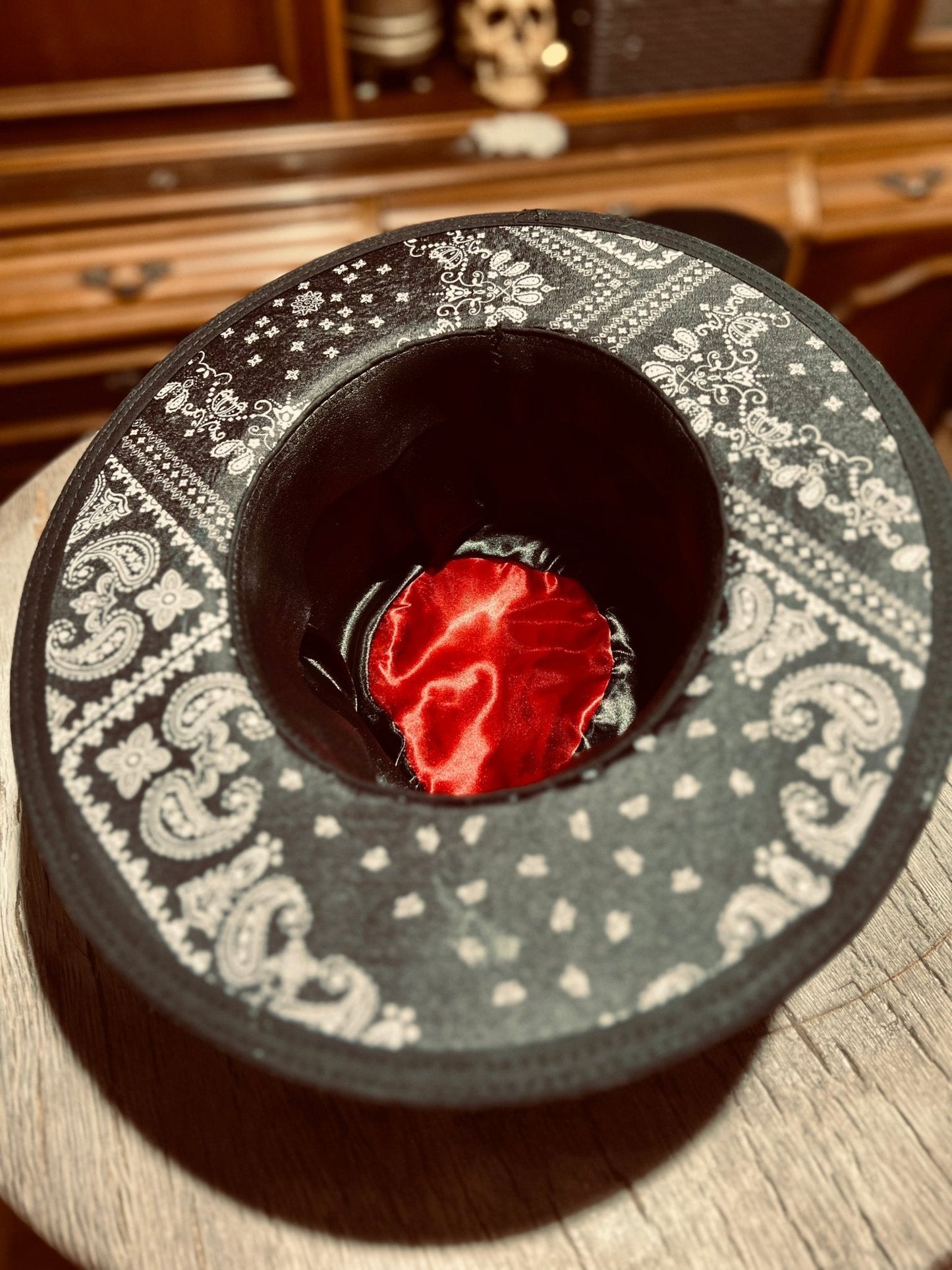 Inside view of JonHats authentic distressed skull hat showing black and white patterned lining with red satin centre