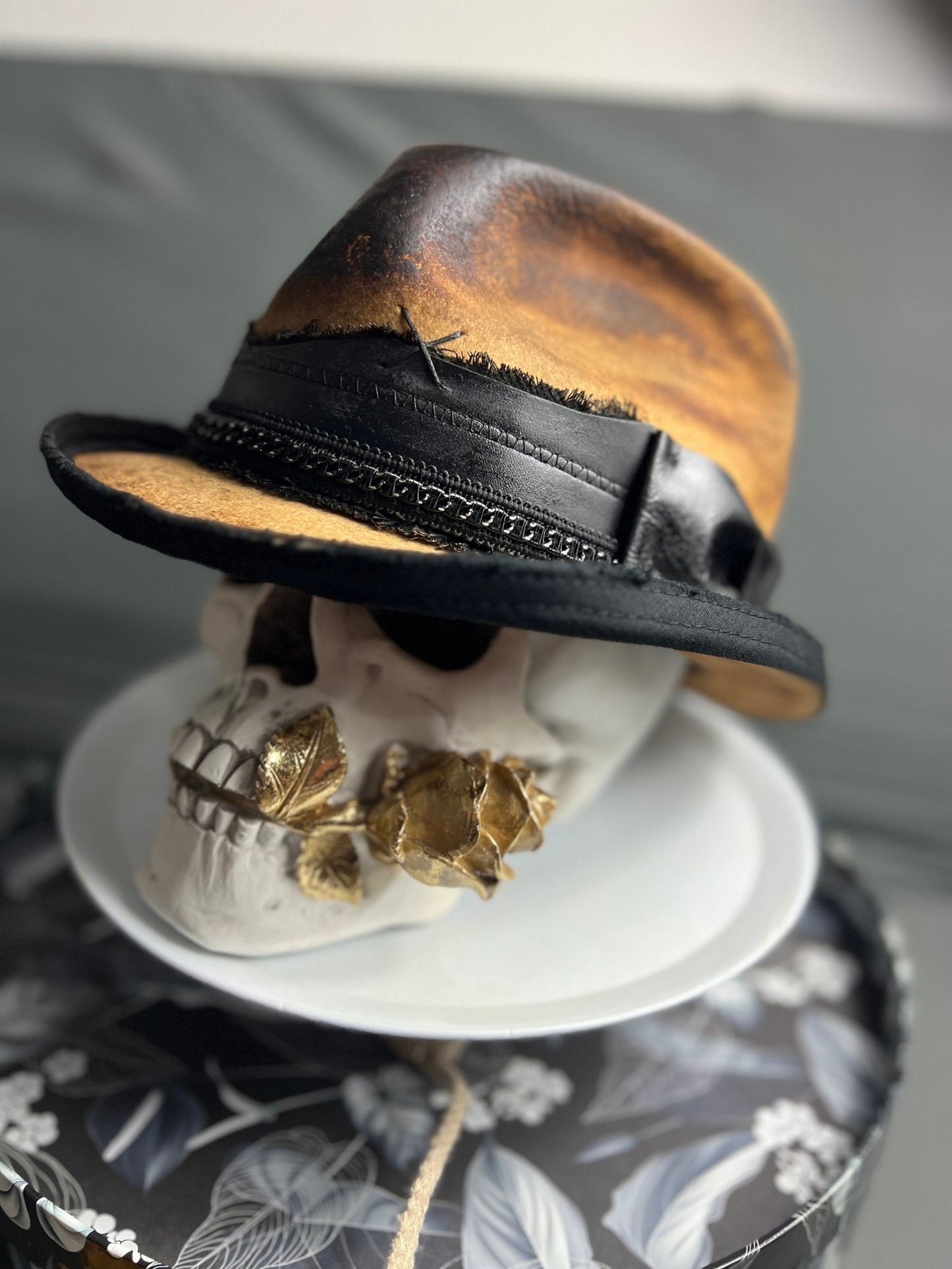 Boho vintage distressed hat in brown and black leather style by JonHats on decorative skull display