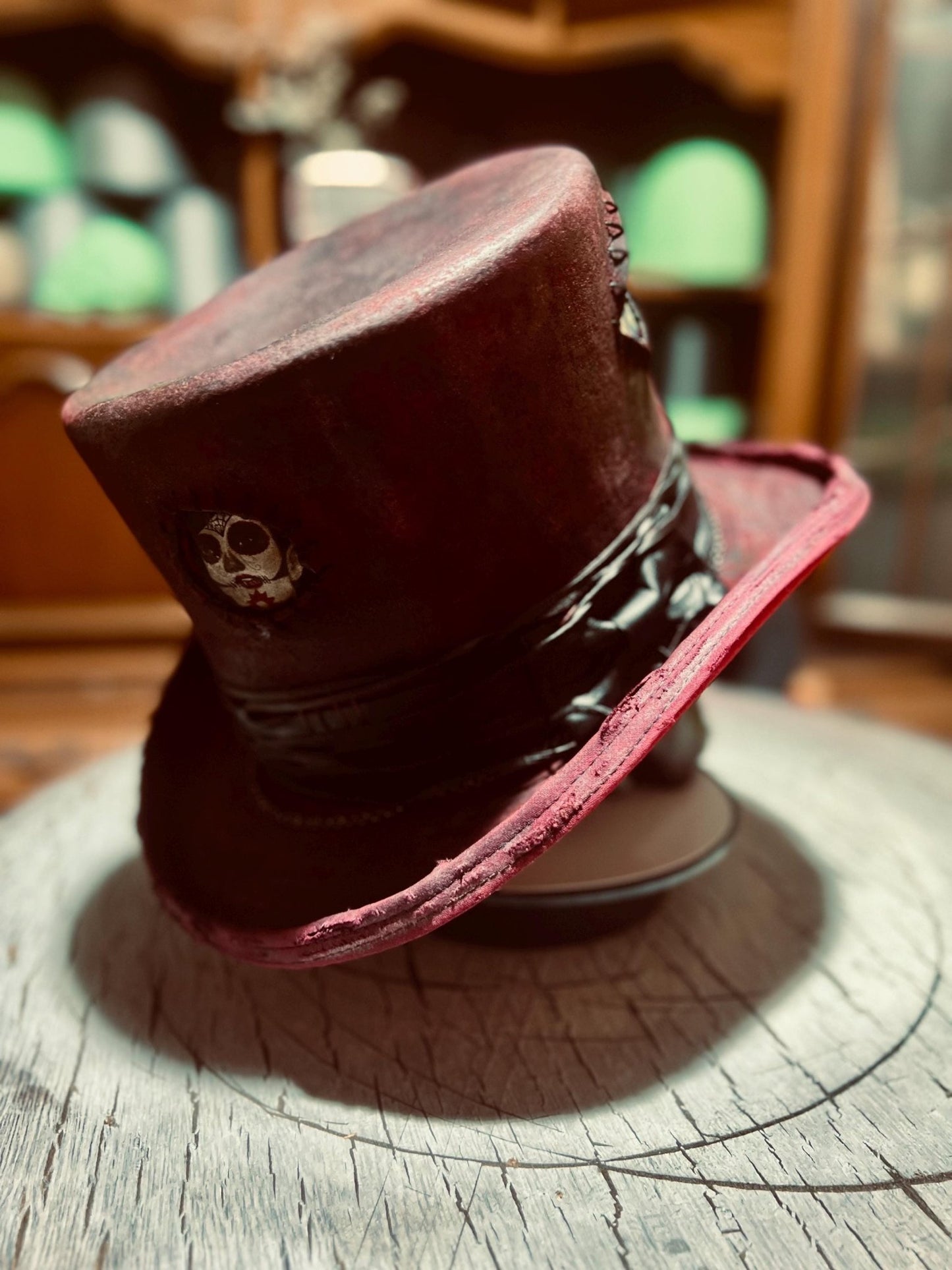 Custom distressed top hat in dark red with skull accents and black band by JonHats