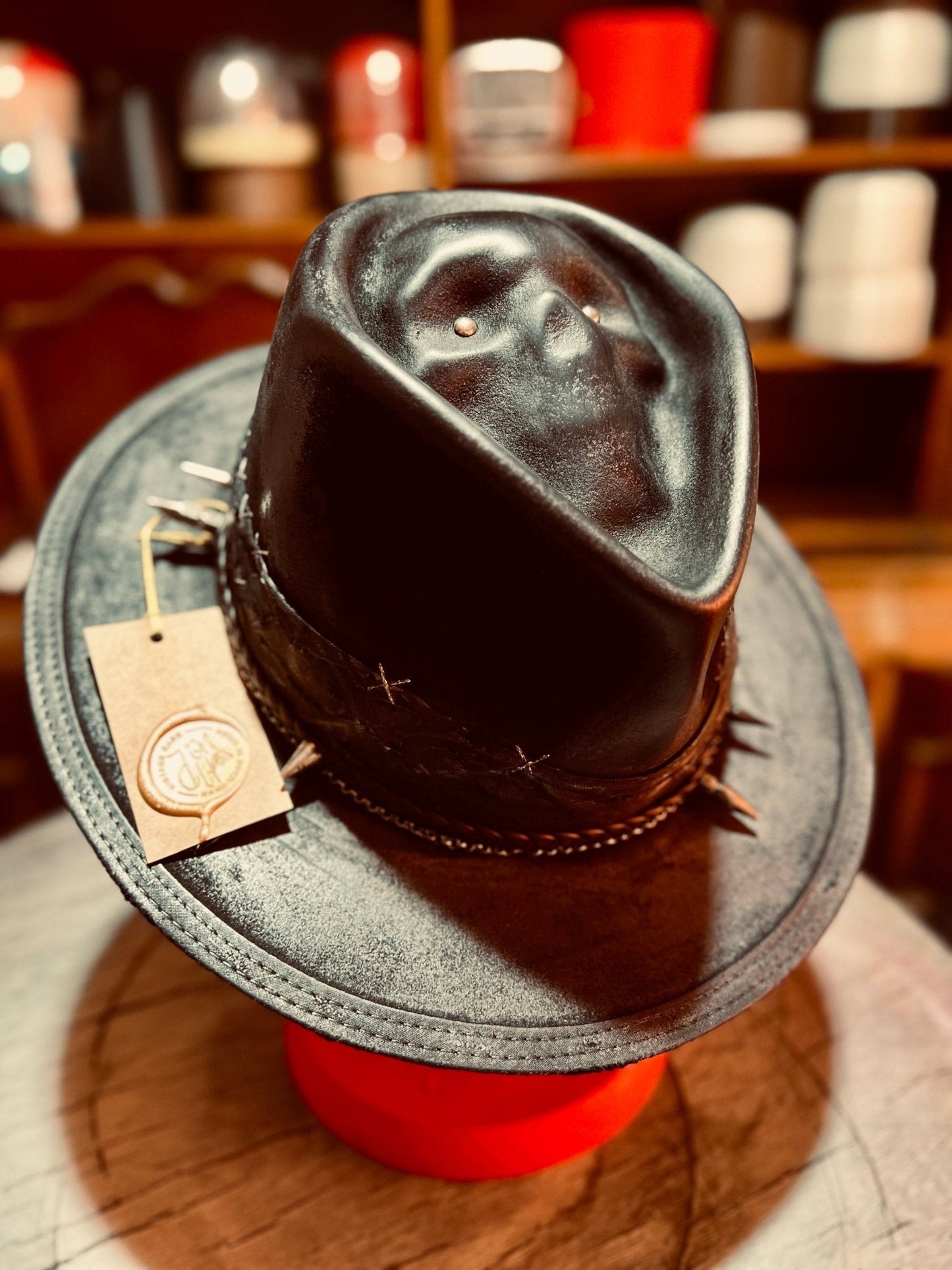 Handcrafted vintage gothic hat in black leather with decorative stitching and unique design