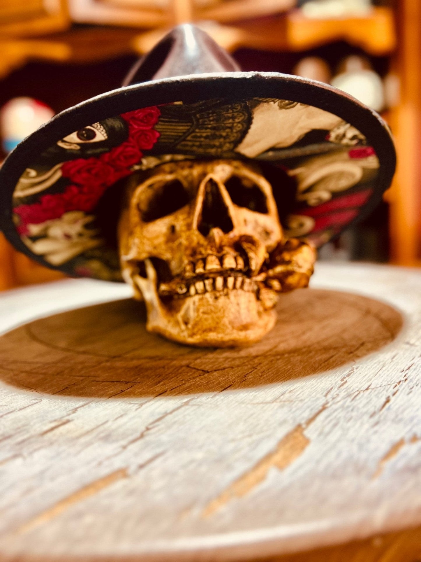 Handmade vintage distressed hat displayed on a decorative skull on a wooden surface