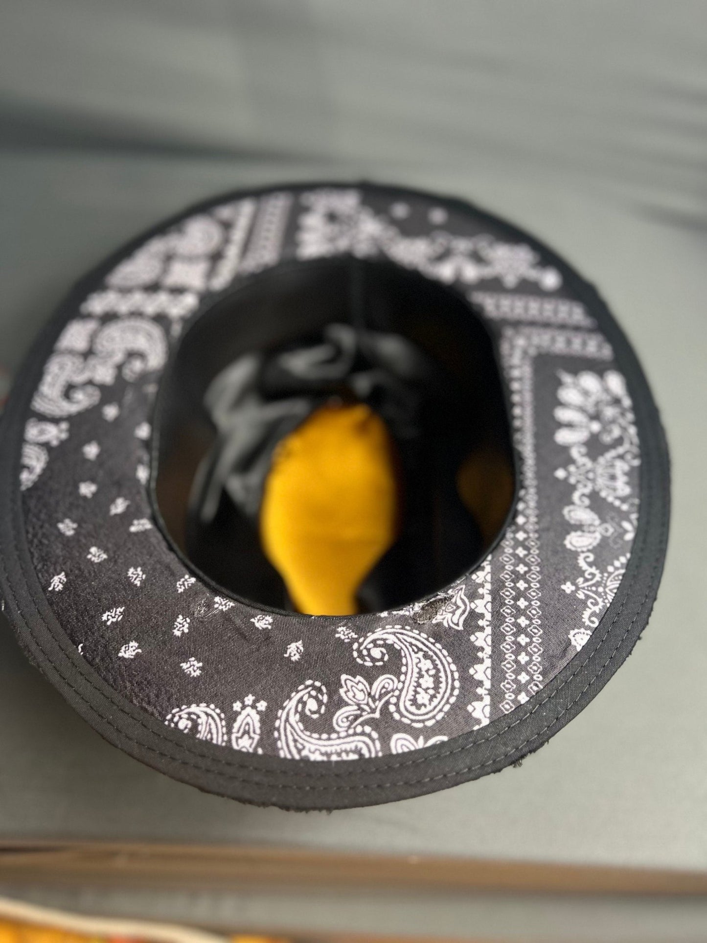 Handmade vintage fedora by JonHats featuring black fabric with white paisley print interior