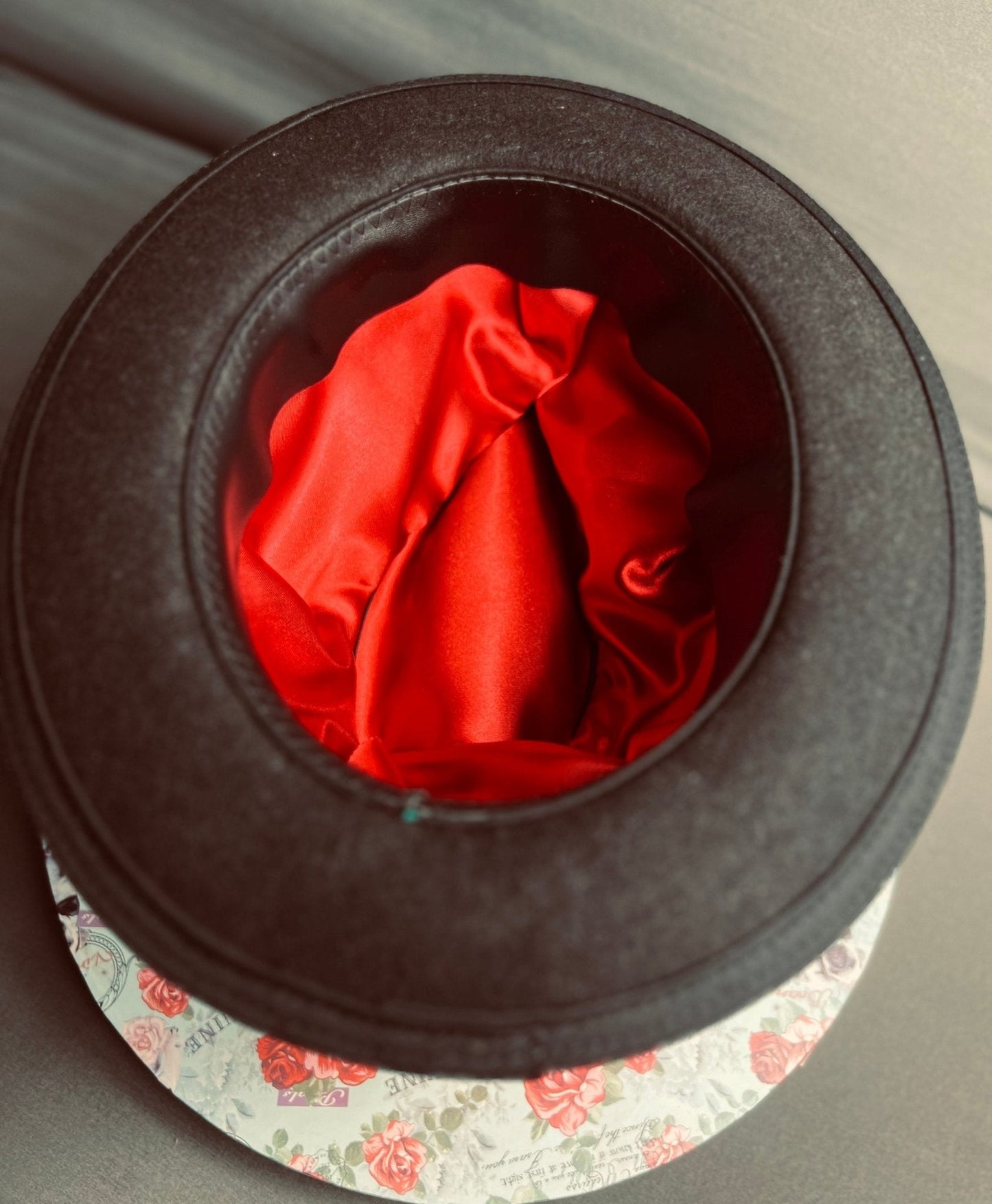 Luxury men's classic fedora hat by JonHats showing black exterior and red satin interior lining
