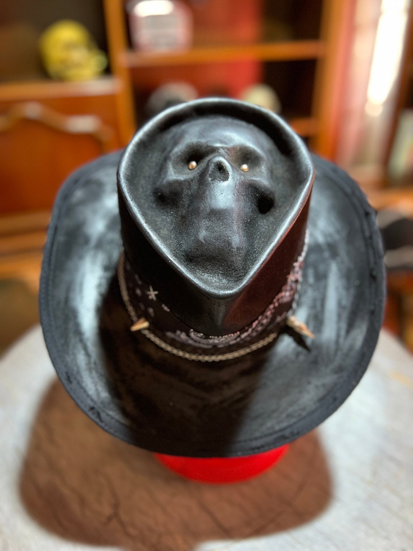 Black skull themed cowboy hat with embossed skull design and decorative band by JonHats