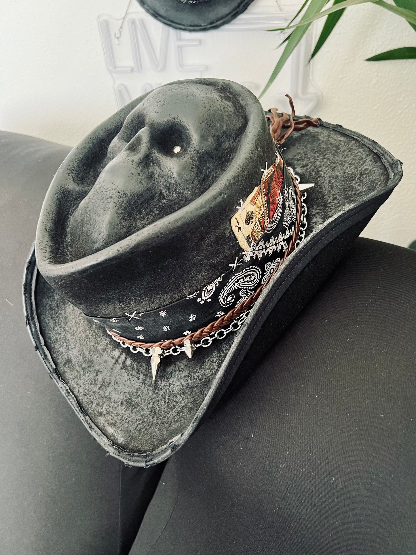 JonHats skull themed cowboy hat in black with decorative band featuring chains and bandana design