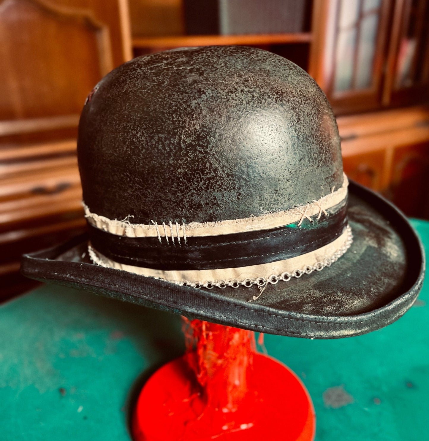 Unique handcrafted vintage hat in distressed black with beige band by JonHats on red stand
