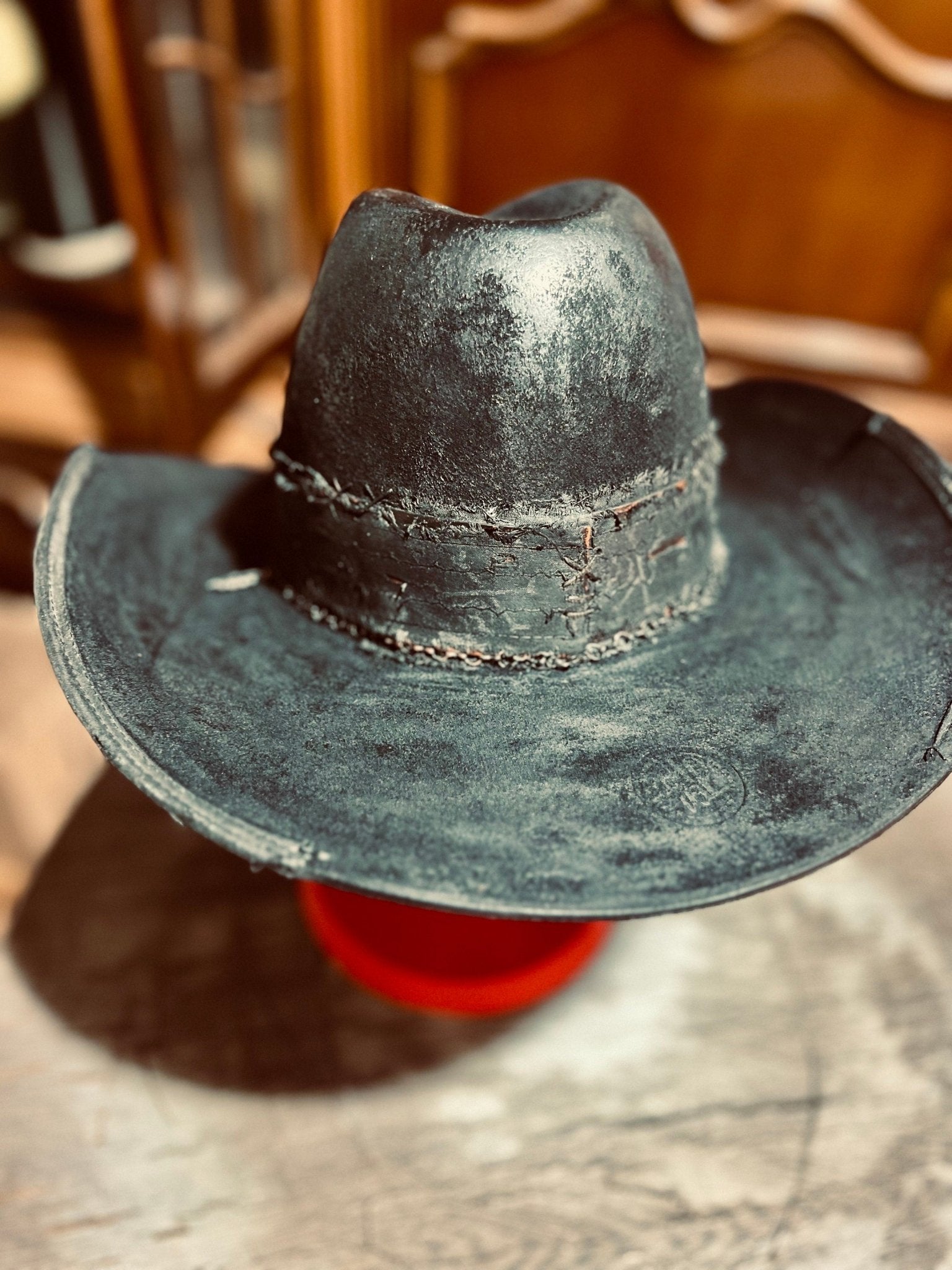 JonHats western distressed hat handmade in black with rustic worn texture and braided band detail