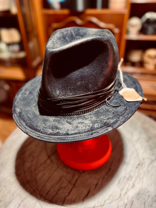 JonHats authentic handcrafted vintage hat in black with decorative band and tag on display