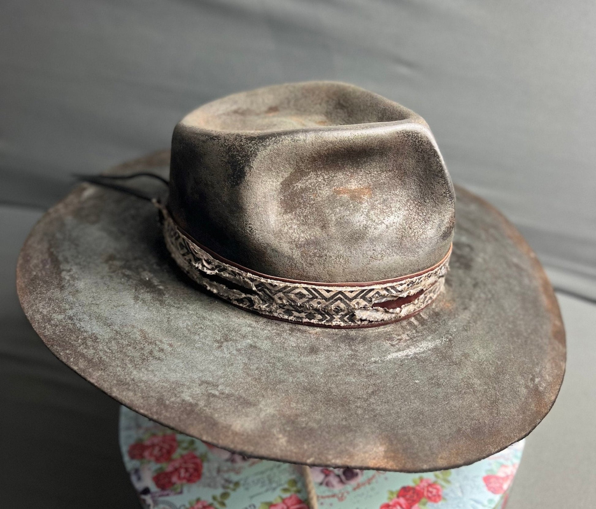 Exclusive handcrafted hats by JonHats featuring a weathered grey leather design with decorative band