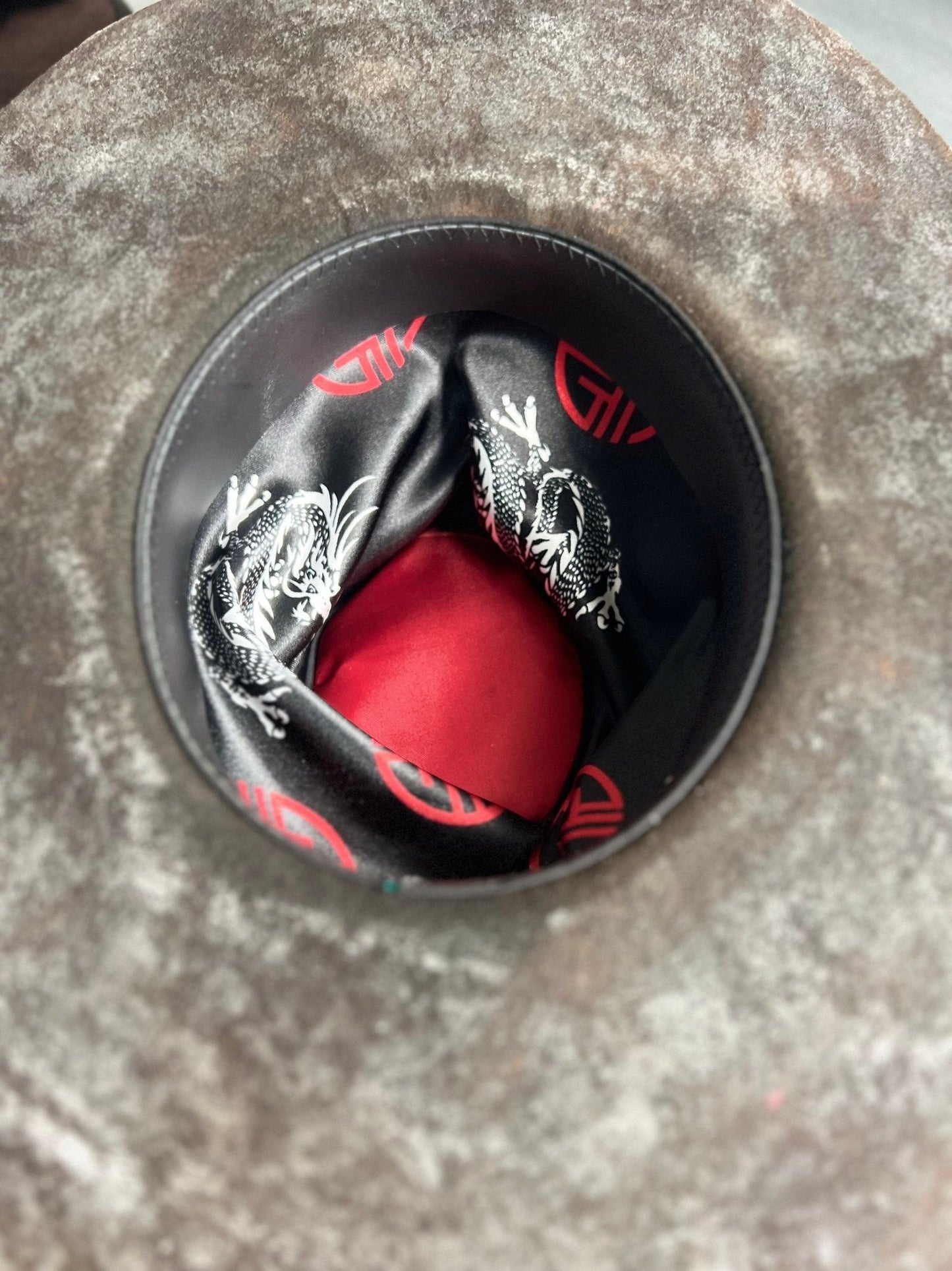 Inside view of JonHats exclusive handcrafted hats showing detailed inner lining with dragon design