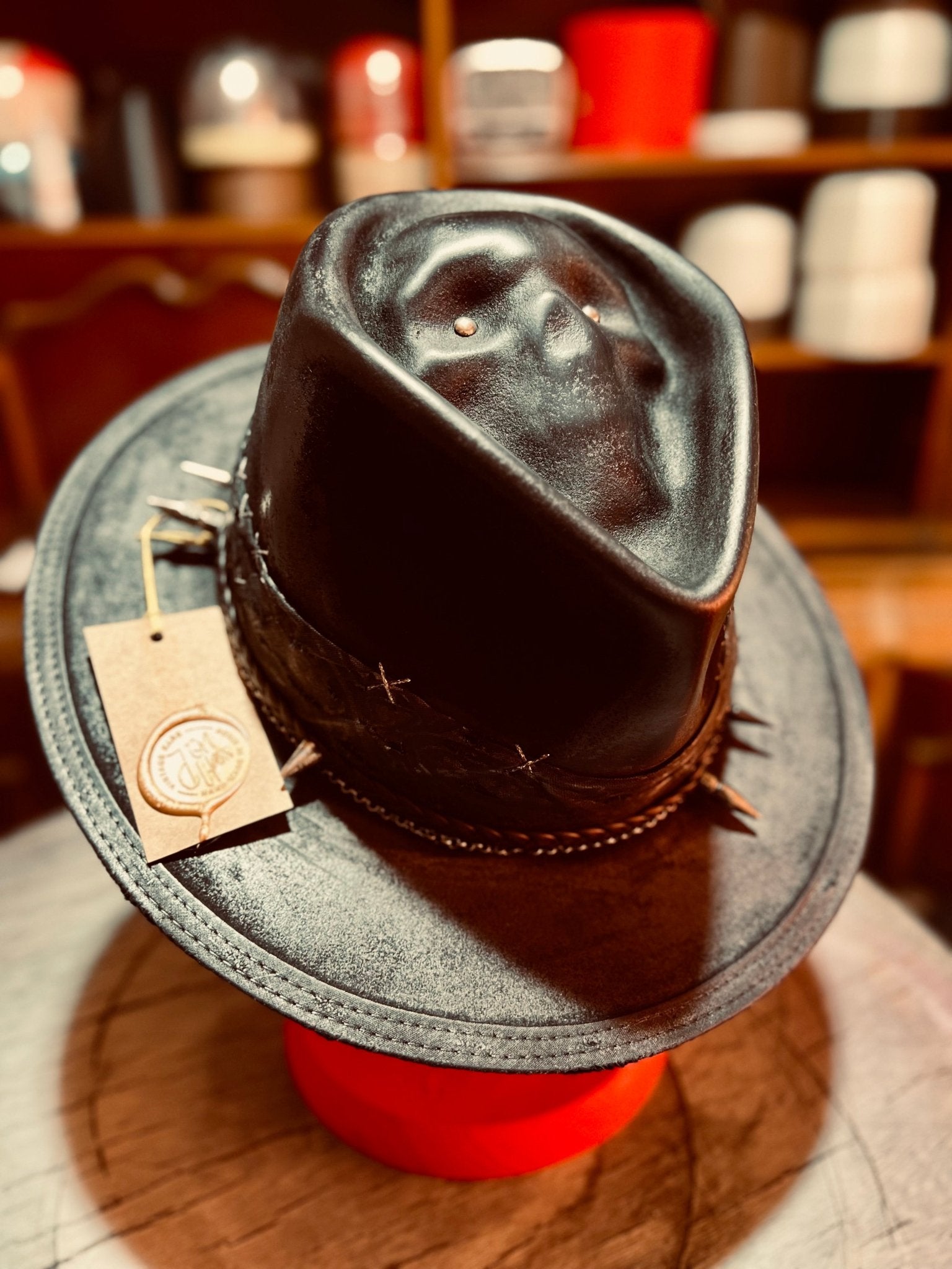 Handcrafted vintage gothic hat in black leather with decorative stitching and unique design