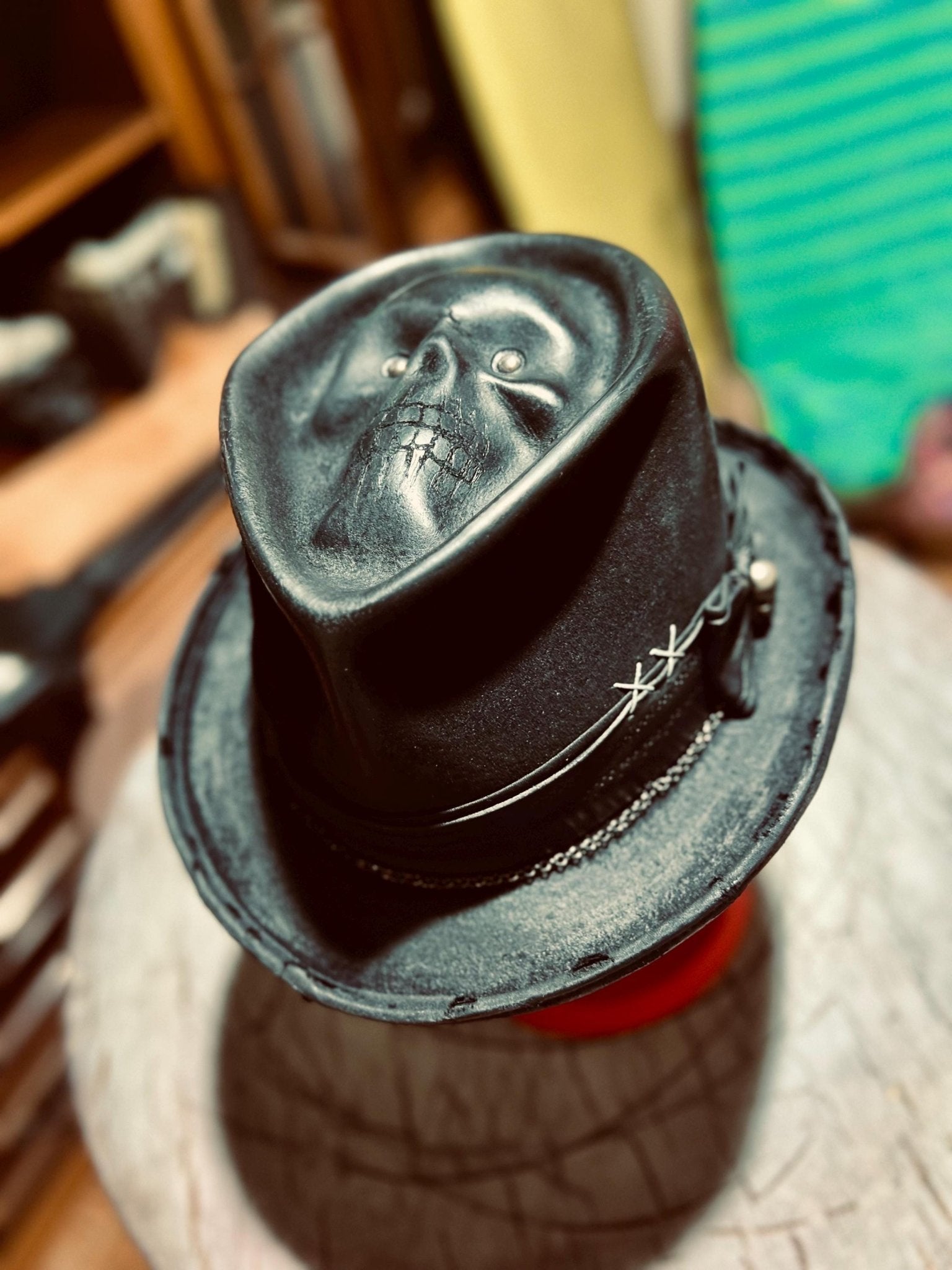 JonHats handmade distressed fedora in black with skull design and stitched detailing on brim