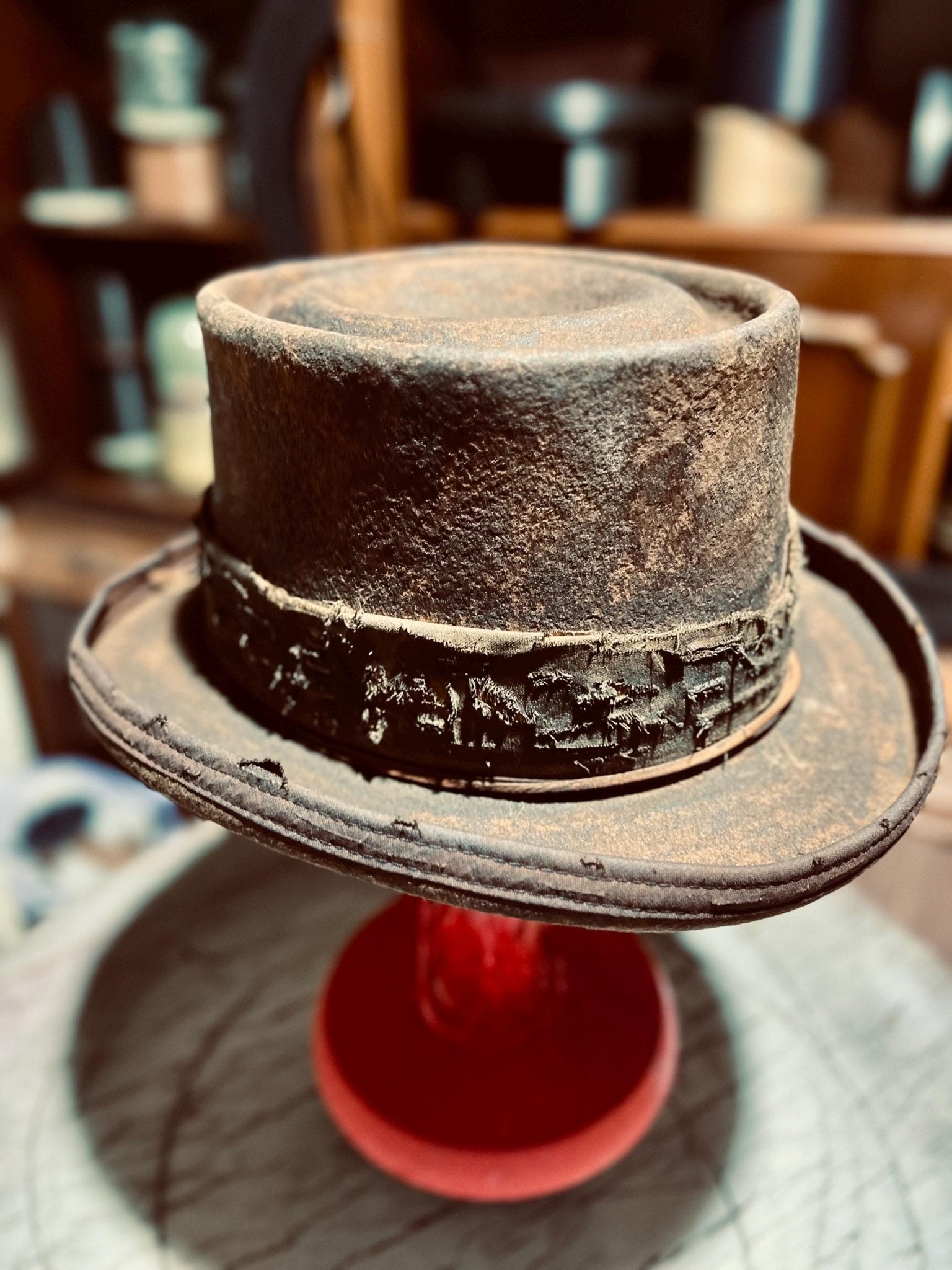 JonHats handmade western hat with distressed leather and rustic detailing on display