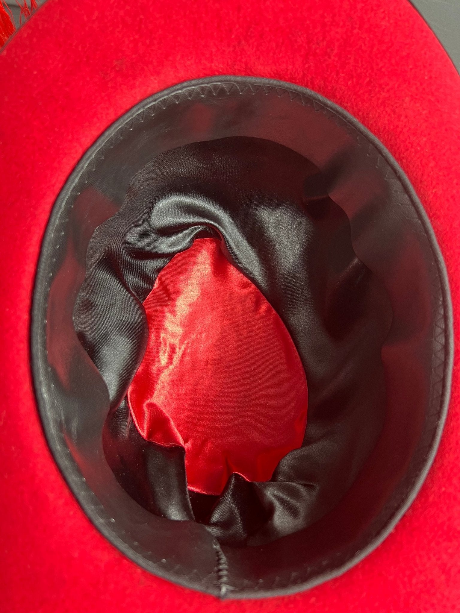 Inside view of JonHats luxury bespoke vintage fedora with black satin lining and red fabric center