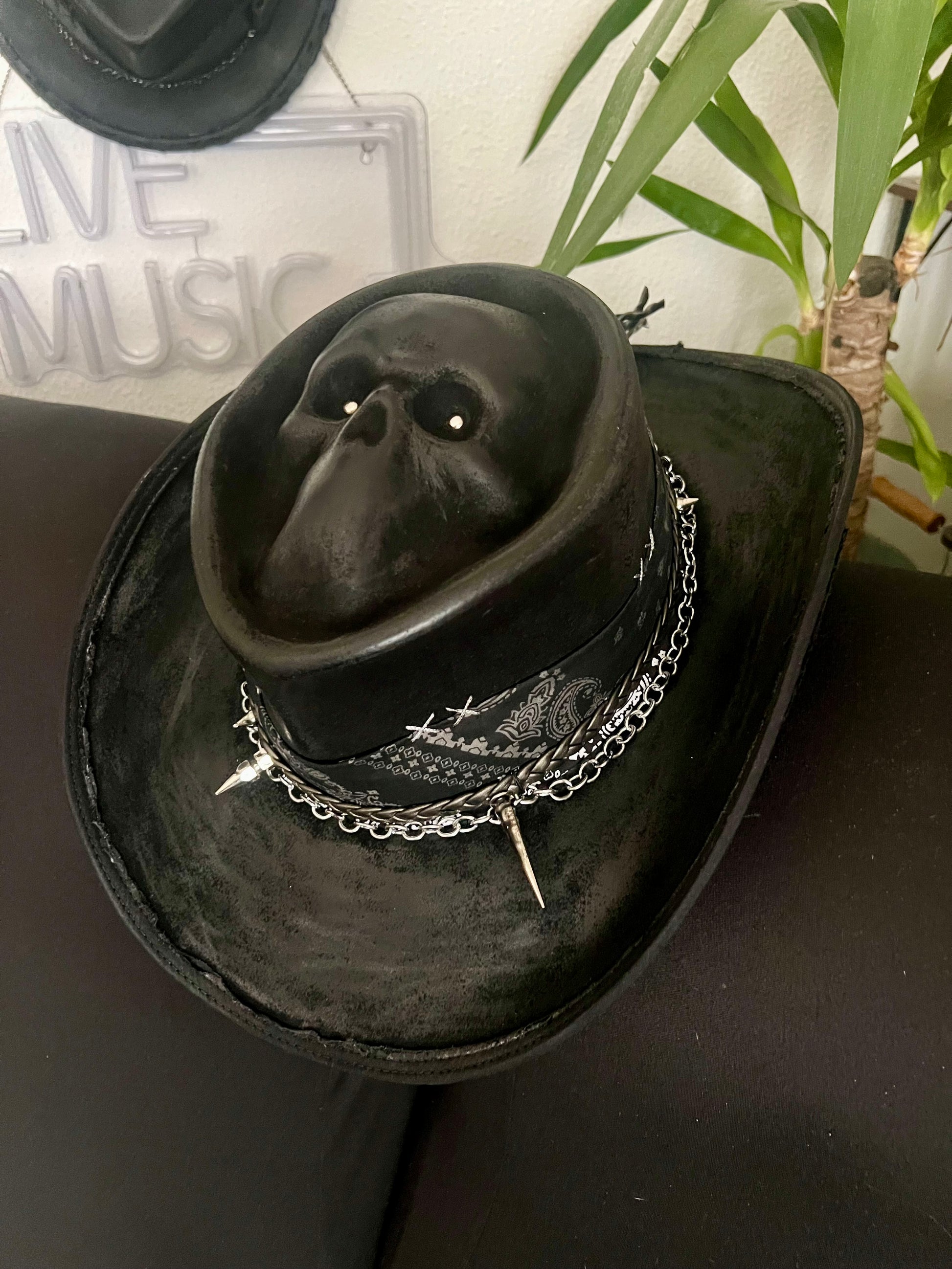 Black skull themed cowboy hat by JonHats featuring skull design and silver chain detail